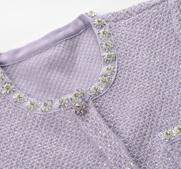 Lavender top with floral embellishments on a white background