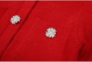 Silver floral earrings on a red fabric background