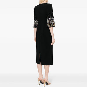 Black dress with patterned sleeves on a white background
