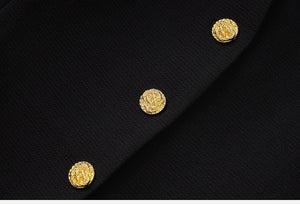 Close-up of a black fabric with gold buttons
