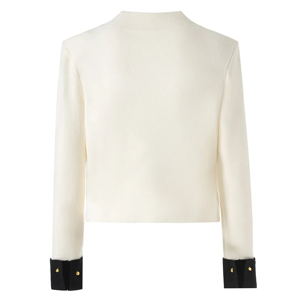 White blazer with gold buttons and black cuffs on a white background