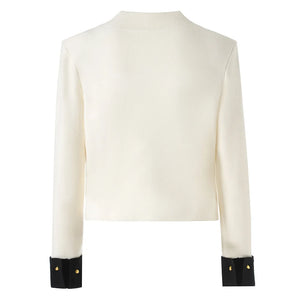 White long-sleeve top with black cuffs on a white background
