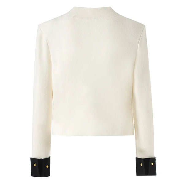 White long-sleeve top with black cuffs on a white background