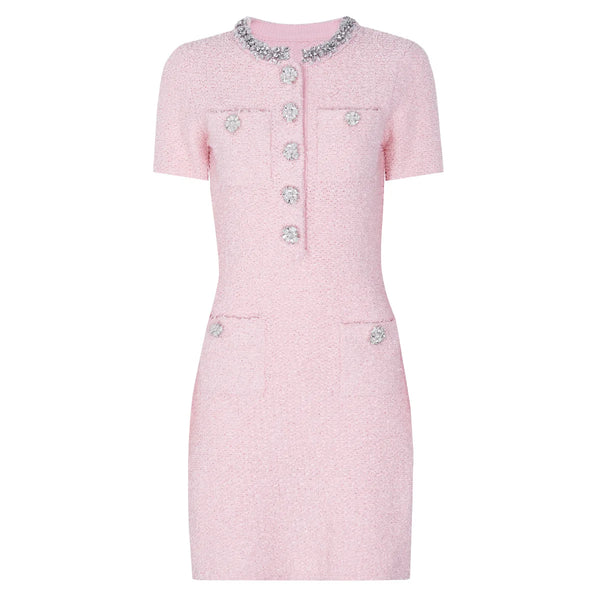 Pink dress with decorative buttons on a white background