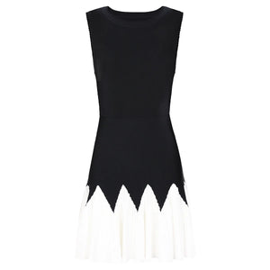 Black sleeveless dress with white trim on a white background