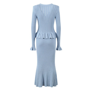 Light blue ribbed dress with peplum waist on a white background