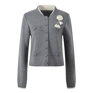 Gray cardigan with floral embellishment on a white background