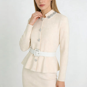 Woman wearing a cream-colored blazer with decorative buttons on a white background