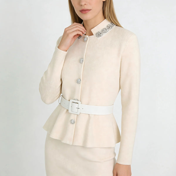 Woman wearing a cream-colored blazer with decorative buttons on a white background