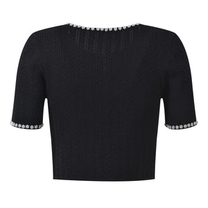 Black short-sleeve top with decorative trim on a white background