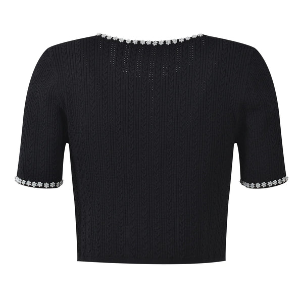 Black short-sleeve top with decorative trim on a white background
