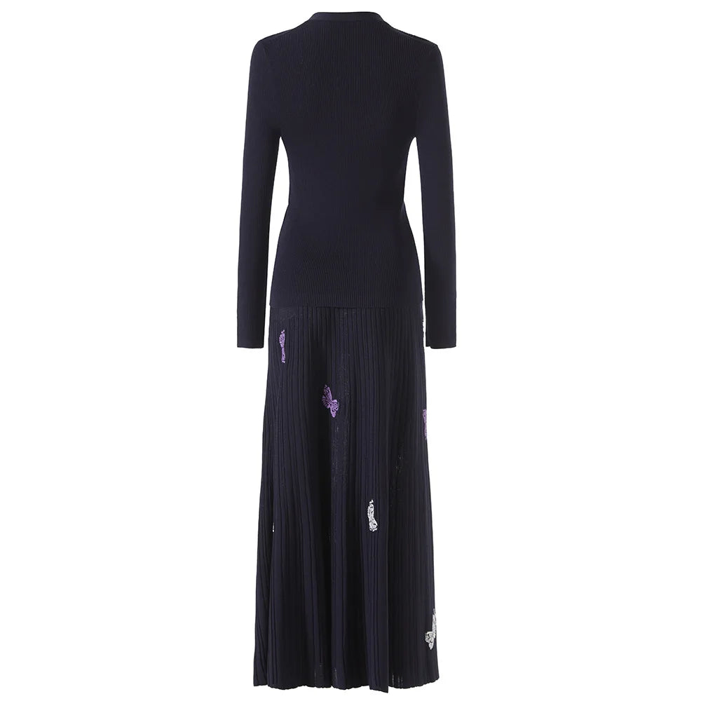 Black dress with purple floral embroidery on a white background