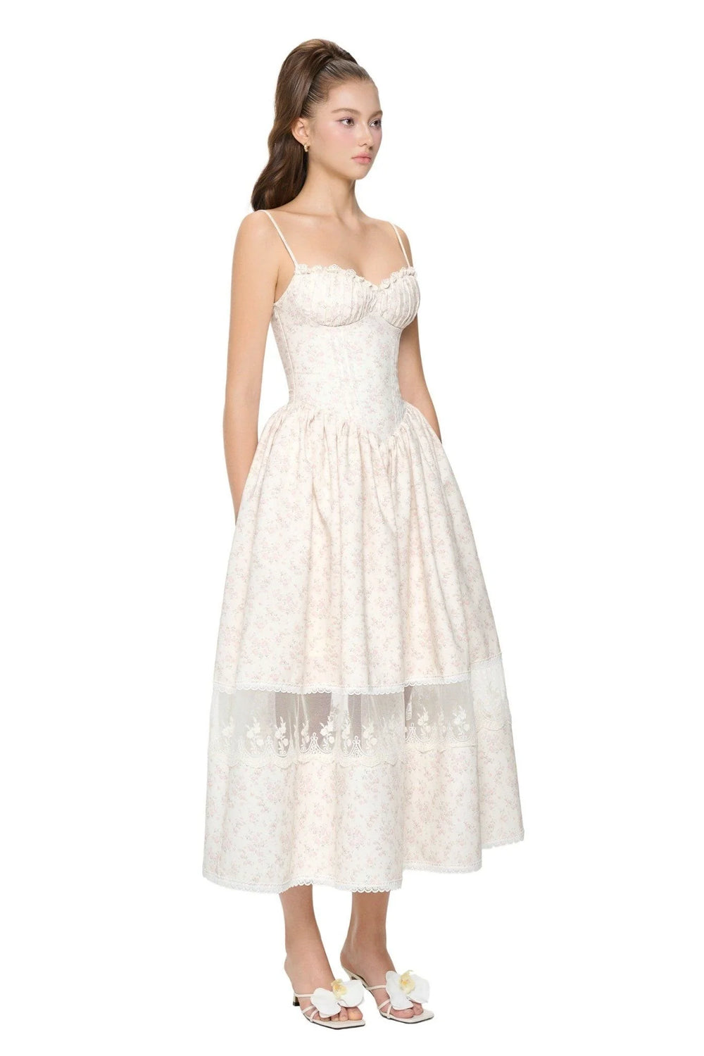 White lace dress worn by a model on a white background