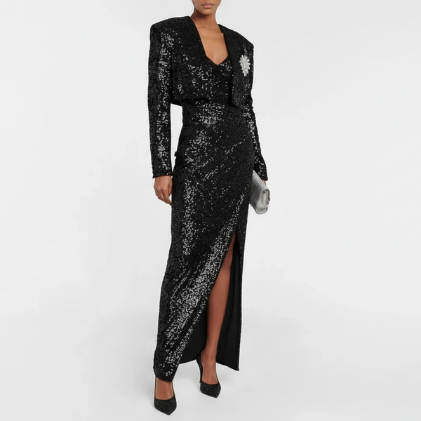Black sequin dress with long sleeves and a slit on a white background