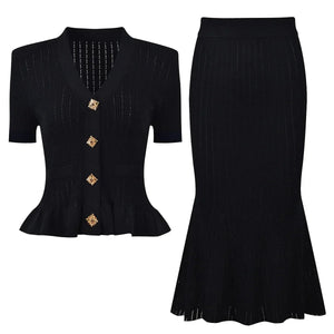 Black peplum top with gold buttons and black skirt on a white background