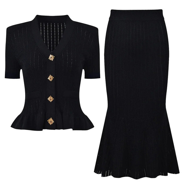 Black peplum top with gold buttons and black skirt on a white background