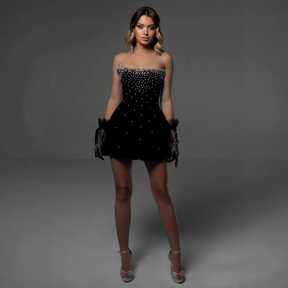 Indulge in luxury with our Black Color Strapless Shinning  Bodycon Dress. This mini bandage dress is perfect for a night out at the club or a glamorous party. Its sl