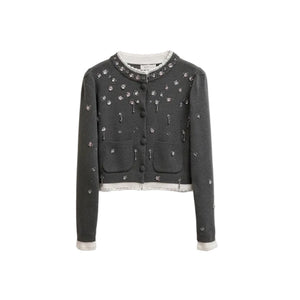 Dark gray embroidered jacket on a wooden hanger against a neutral background