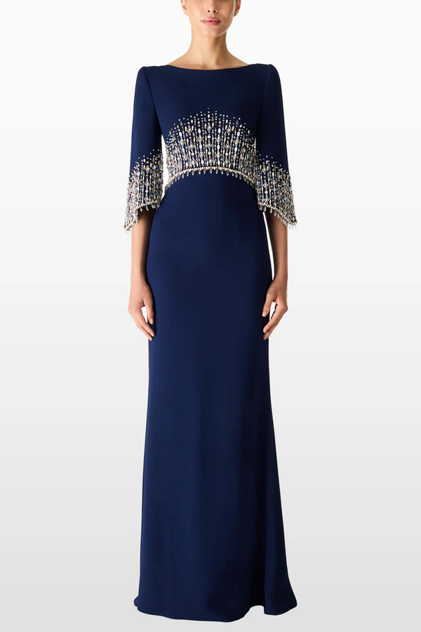 Navy blue evening gown with embellished sleeves on a white background