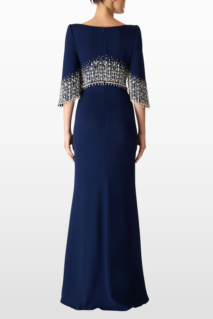 Navy blue evening gown with embellished sleeves on a white background