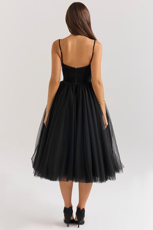 Black tulle dress worn by a model on a white background