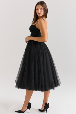 Woman wearing a black tulle dress on a white background