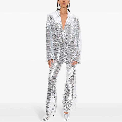 Person wearing a silver sequin suit on a white background