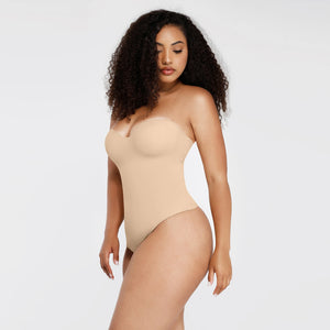 Woman wearing a beige strapless bodysuit on a white background