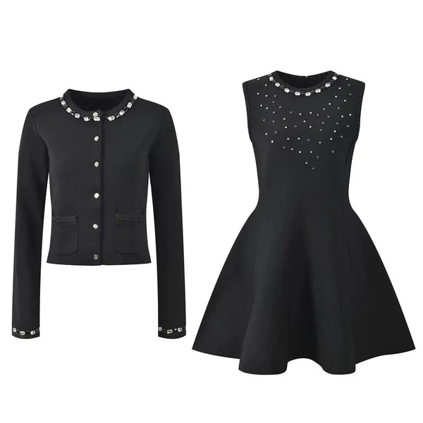Black jacket and dress with decorative elements on a white background