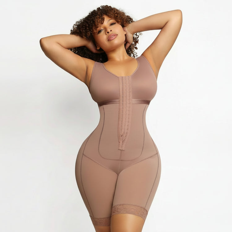 A woman modeling a sleeveless, mid-thigh body shaper in a dusty mauve-brown color, standing against a plain light background.
