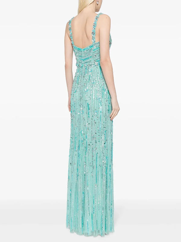 Mint green beaded evening gown on a white background