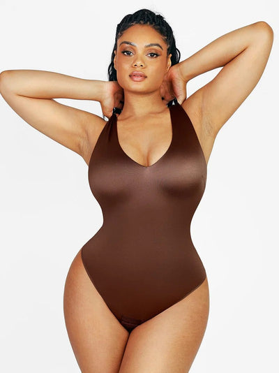 Woman wearing a brown swimsuit against a white background