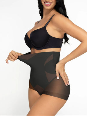 Woman wearing a black bra and shapewear on a white background