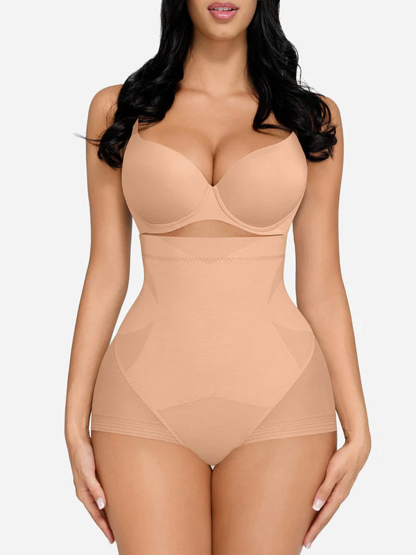 Woman wearing a beige shapewear bodysuit on a white background