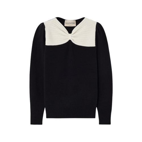 Black sweater with a white bow detail on a white background