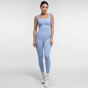 Woman wearing a light blue jumpsuit on a white background