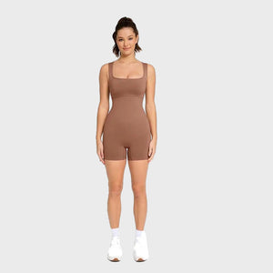 Woman wearing a brown bodysuit on a white background
