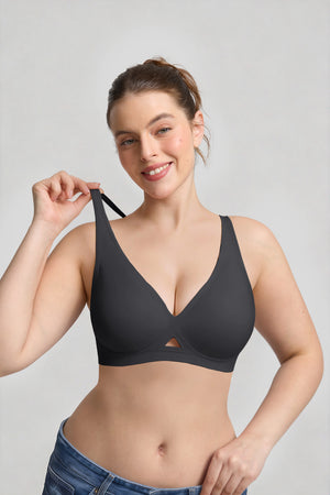 Woman wearing a black bra against a plain background